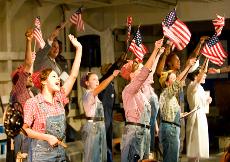 Rosie the Riveters proudly wave the American flag. (Courtesy of Brett D’Ambrosio)