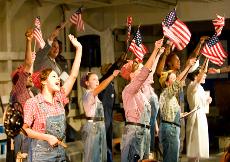"Rosie the Riveters" proudly wave the American flag. (Courtesy of Brett D’Ambrosio)