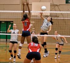 Kristen Kemp spikes the ball over an American River playerin the game on Oct. 29, which the Vikings won in three sets.  ()