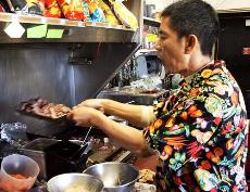 Crows Nests Chef, David Chiu, prepares a bowl of honey beef at the DVC snack shack. ()