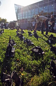 Combat boots line a grassy knoll near the bookstore, each pair representaing a California soldier who died in Iraq. ()