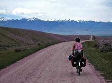 Anne Breedlove fights her way up the grade with the Rocky Mtns in the distance, Montana. (Courtesy of Anne Breedlove)