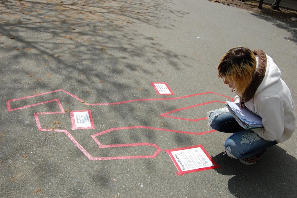 Student Lizbeth Brown reading the outline for day of silence (Mariana Ramos/The Inquirer)