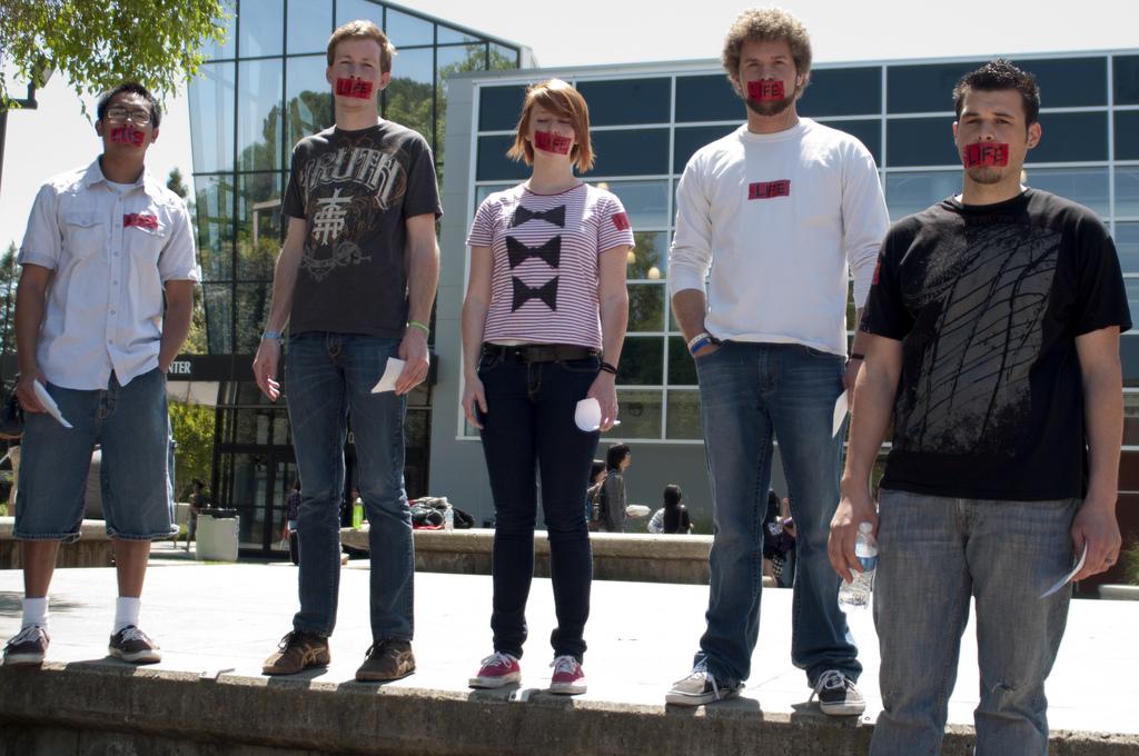 From lest to right, students Jordan Briones, Spencer Struwe, Rebecca Tingey, Ethan Purkey and Gsep Ciccone protest during A Silent Siege. (Stevie Chow / The Inquirer)