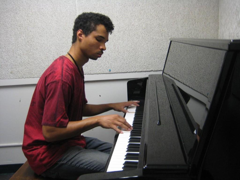 Student Jordan Friday plays piano in the music practice room. He is pursuing the new Music Associate degree. (Alex Brendel / The Inquirer)