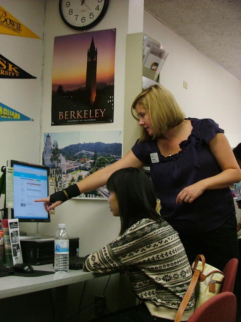Sarah Boland, standing, icarrer and employment services coordinator helps student Tinnie Feng in the new Career, Employment and Transfer Center. (Dorothy Thornton)