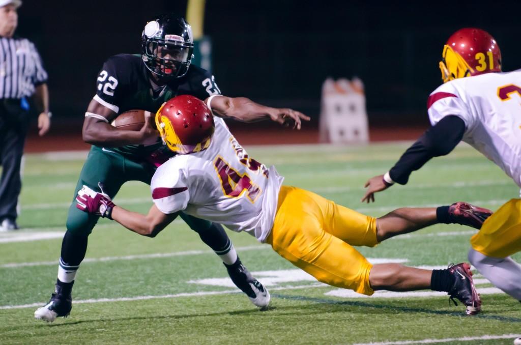 Dozie Iwaugwu runs over Raymond Bautista in DVC’s 51-3 rout of Sacramento City College on Oct. 7. (Stevie Chow / The Inquirer)