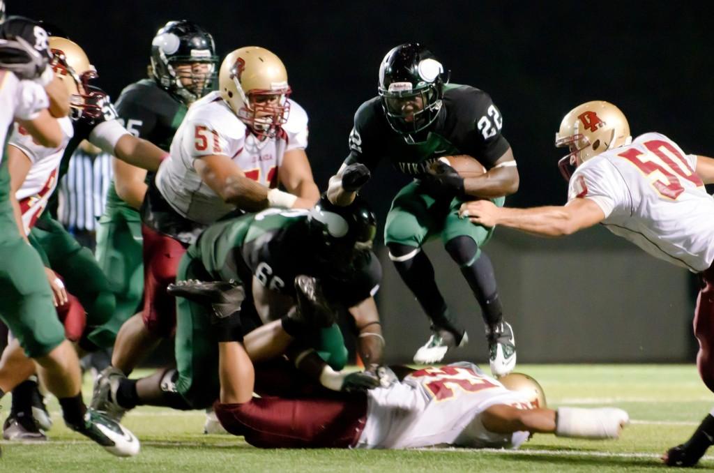 Dozie Iwaugwu (22) hurdles the defense on his way down the field in the Vikings 35-20 domination of the De Anza Dons. Iwaugwu had two rushing scores. (Stevie Chow / The Inquirer)