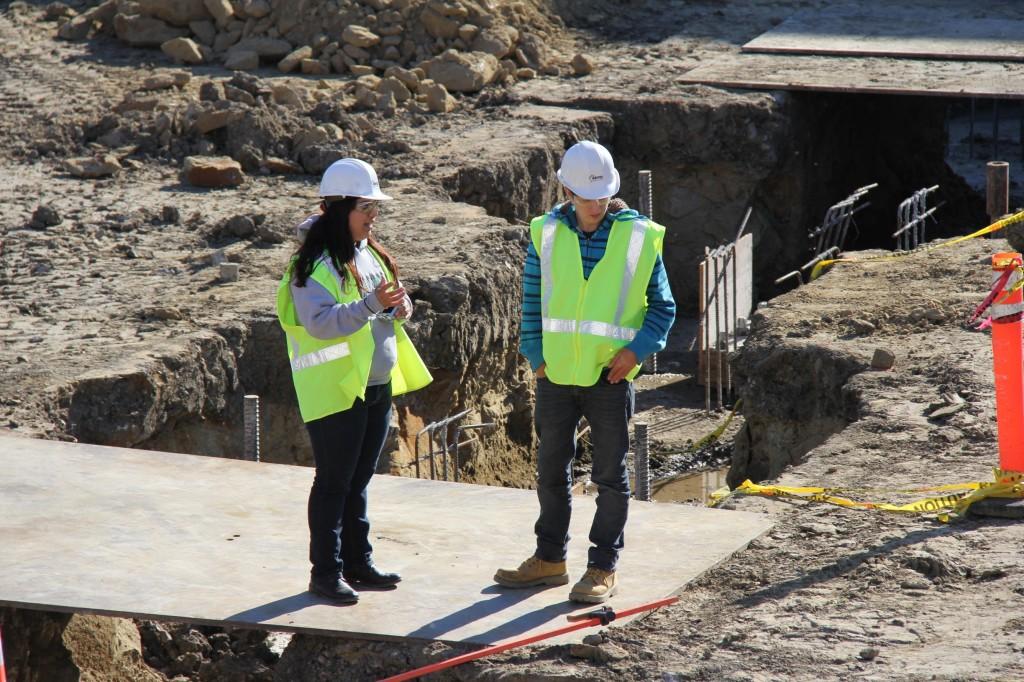 Engineering majors Fabiola Ramirez and Chris Mason, left to right, discuss the project in the construction zone in the middle of campus on Dec. 1, 2011. Both are interns for Flintco, the prime contractor of the $52  million  project. ()