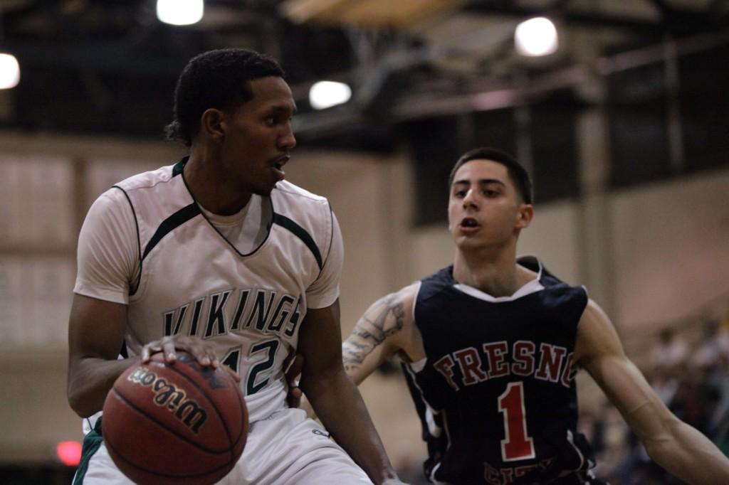 The Vikings Greg Holmes tries to move the ball past Alex Perez and a persistent Fresno defense that controlled the game during DVCs loss in the 2nd round of playoffs on Wednesday Feb. 29. (Mike Alfieri/ The Inquirer)