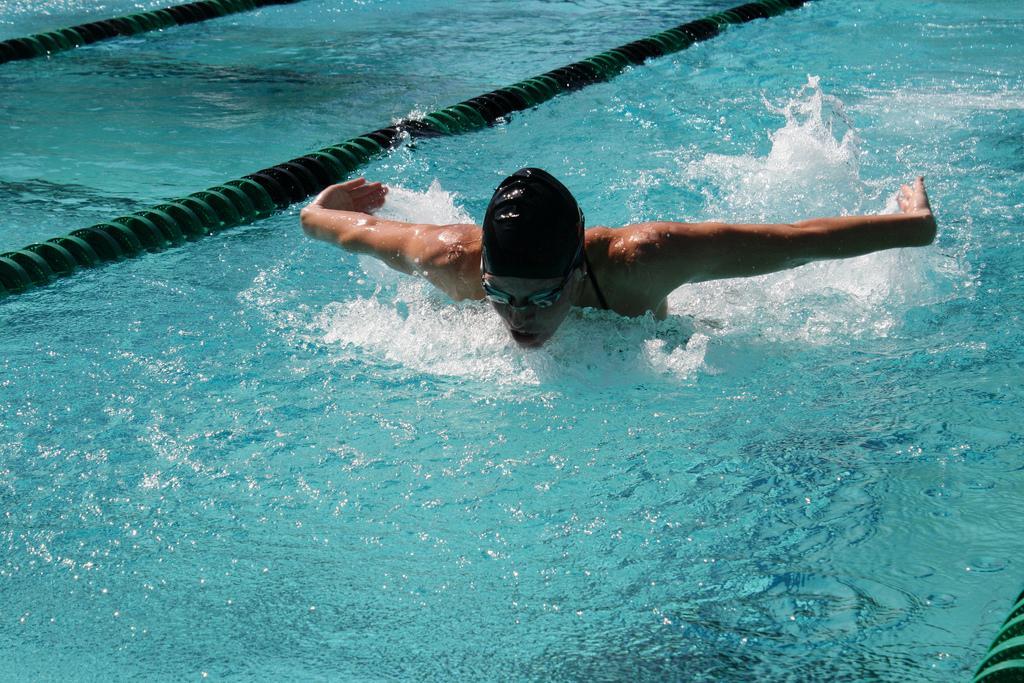 Hannah Voegtly burns through an intense heat of 100 yard butterfly. She finished first place in her heat. (Sean Wilkey)
