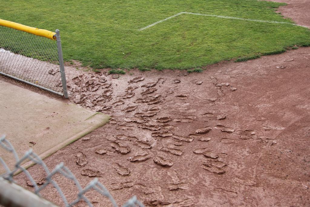 Muddy footprints left by players anxious to take the field after being rained out last weekend. (Alex Brendel)