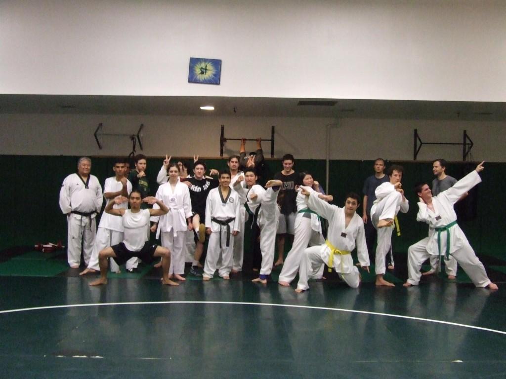 Tae Kwon Do instructor Arnaldo Bolanos (center) stands with his eclectic group of students. Tae Kwon Do is one of many martial arts classes that is filled to the brim with eager minds and souls. (Billy Morcillo)