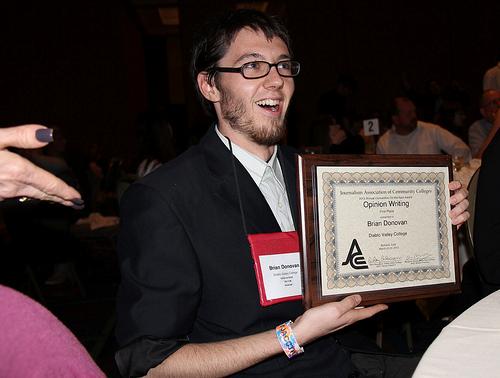 Editor-in-Chief Brian Donovan smiles as he receives an award for on-the-spot opinion writing (Alex Brendel)