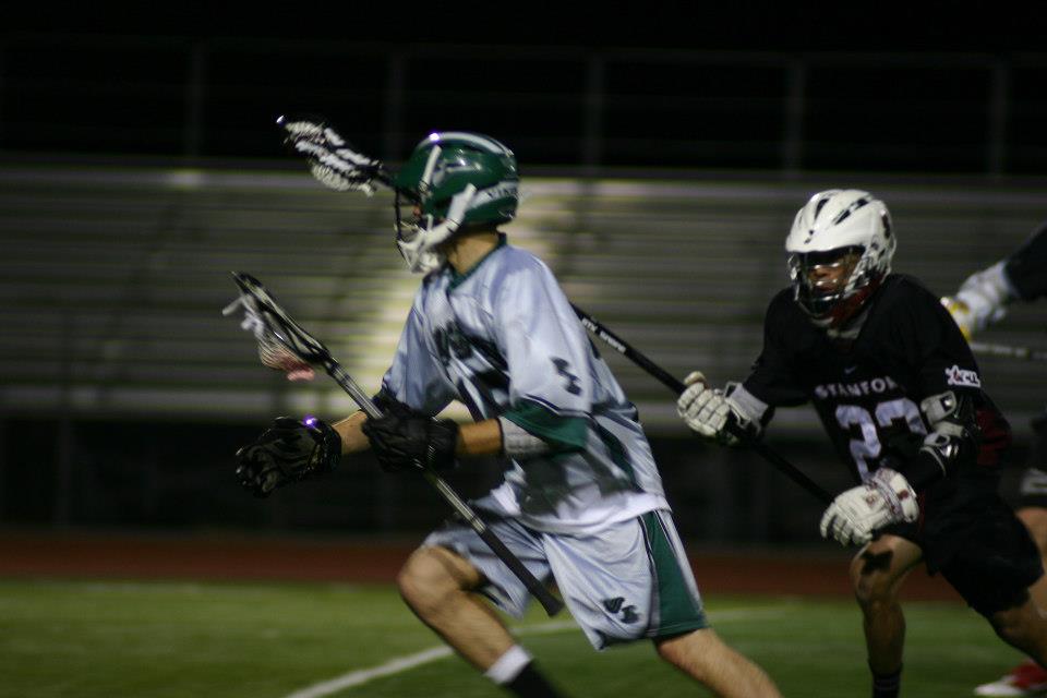 Midfielder Cory Callahan eludes Stanford defender while running across the field. Callahan scored five of twelve goals against Stanford, helping DVC to win 12-11.