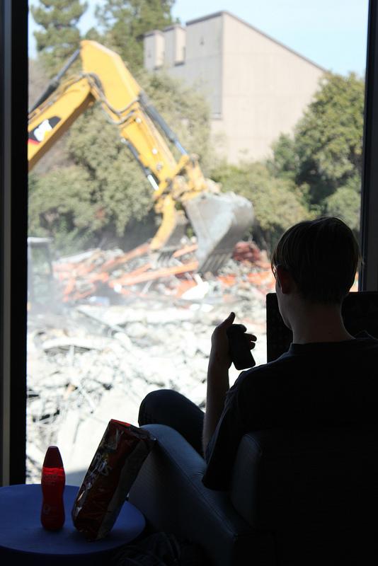 DVC student looks on as demolition of the old student services building. (Karin Jensen/Inquirer)