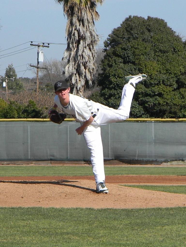 Starting pitcher Ben Krauth after delivering a pitch in a baseball game versus West Valley