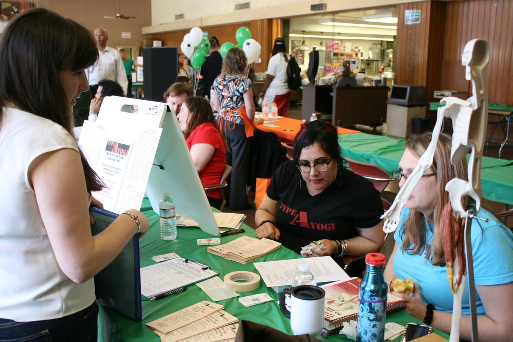 DVC student Nora Pallotta, left, talks with Autumn Maltbie, middle, and Adri Frick, right, about the job opportunities Type A Yoga has to offer at the job fair on Wednesday, March 13, 2013.

(Alejandro Ramos/The Inquirer)