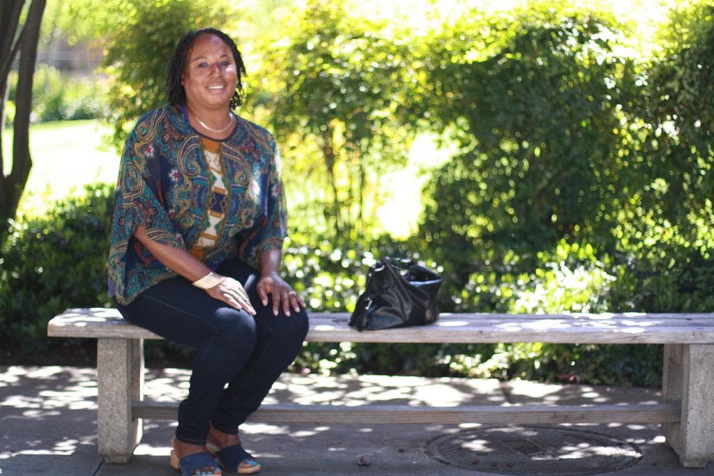 Pamela Smith sits on a bench