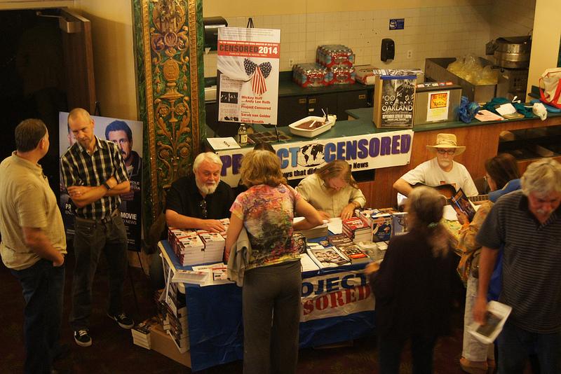 (Left) Peter Phillips, former director, and (RIght) professor Mickey Huff signing books at the Project Censored sales desk. (Benjamin Davidson/ The Inquirer)