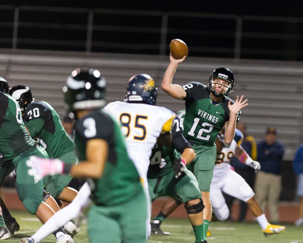 Quarterback Adam Wood throws a quick pass to wide receiver Tre Dean.