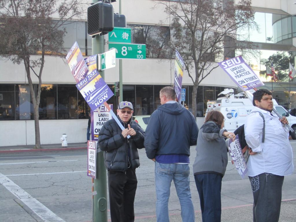 Protesters from the Service Employees International Union (SEIU) local 21 union protest at the Lake Merritt BART station in Oakland, Calif. on Monday, Oct. 21, 2013 (Collin James/ The Inquirer).