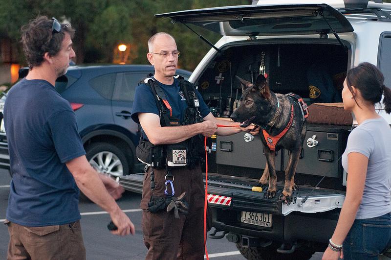 CARDA handler Mark Herrick and his search dog Kapo are prepping for Monday's search and rescue exercise on campus. Herrick is explaining strategy to CARDA apprentice Karl McDade and a prospective volunteer (Gustavo Vasquez/ The Inquirer).