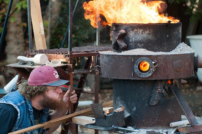 DVC student Chris Fowler is keeping the fire alive during the iron furnace refractory burnout (Gustavo Vasquez/ The Inquirer).