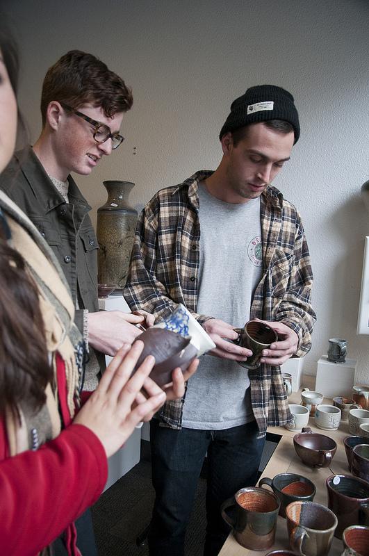Intro to print making students Kelly Loria, Sean Hopkin, and Andrew Sharr viewing pottery at holiday art department sale Tuesday, Dec 3 2013.Photo credit: Gustavo Vasquez