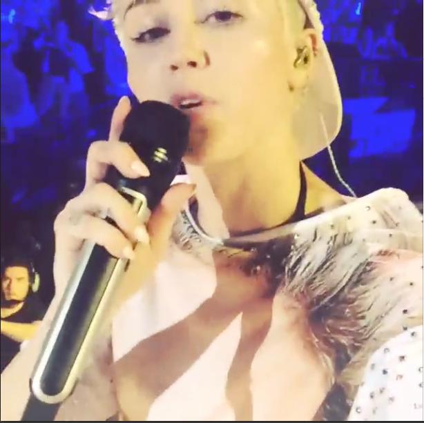 Miley Cyrus, shown above, films an Instagram video during her concert at the Oracle Arena in Oakland on Feb. 24, 2014.