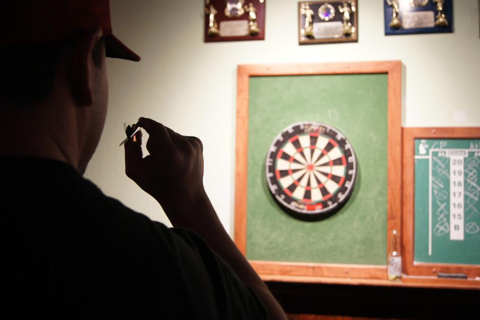 Matt Land, 25, shoots a game of darts with his group of friends on his birthday weekend. Land enjoys his time at Vinnies because of the things that you can do other than just drinking.

Land and his group of friends were finishing up a game of around the world as he sipped his draft beer.