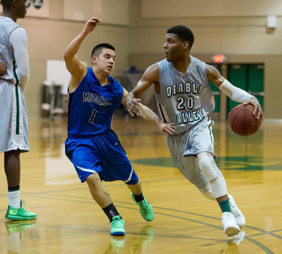 Justin Yeargin (20) tries to drive past Modestos forward on Feb. 21, 2014. The Vikings won 75-66 in their final season home game getting them into the playoffs.