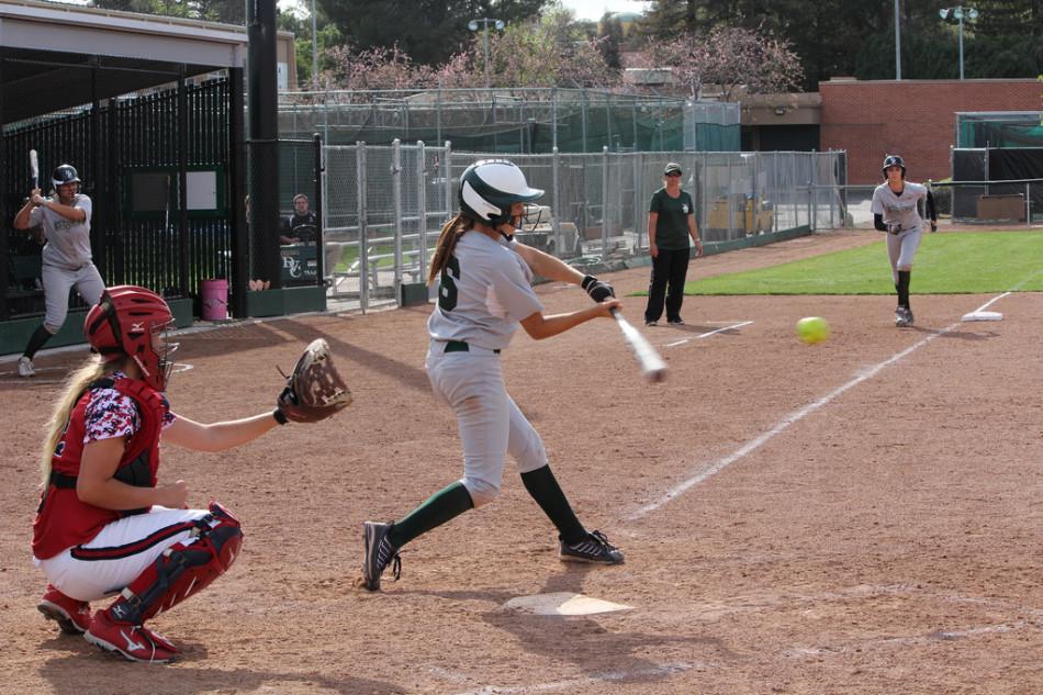 Pitcher Carrie Lee makes solid contact with the ball after a two out at-bat in the bottom of the seventh.

Amber Golini waits eagerly on third as coach Angie Goularte looks on — Lee was the last batter in the loss against Santa Rosa Junior College on Friday, March 28.