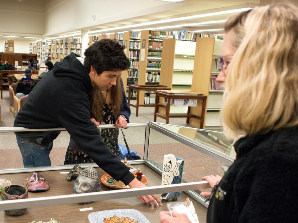 College Park High School student Dylan hill (left) and CPHS ceramics instructor Lesley Jensen (right) setting up display box of ceramic and glass artwork on Monday, Mar. 31, 2014 in the Diablo Valley Library.
The show in the DVC library will be showcases between April 3, through May 18, 2014. Artist reception will be held Thursday, April. 17, 5-7P.M. in L218.