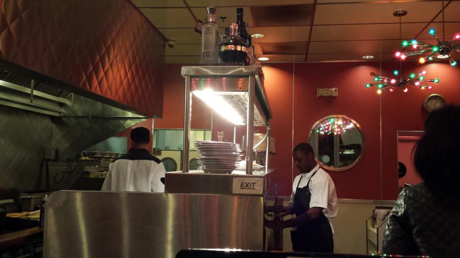 Waiter Josh Phillips is working double-duty, as the busser, pass check and and food server at 1 a.m. on Saturday, April 26 at the Home of Chicken and Waffles in Walnut Creek. Phillips is one of many servers who make the diners feel like theyre part of the family when they walk in the door. 