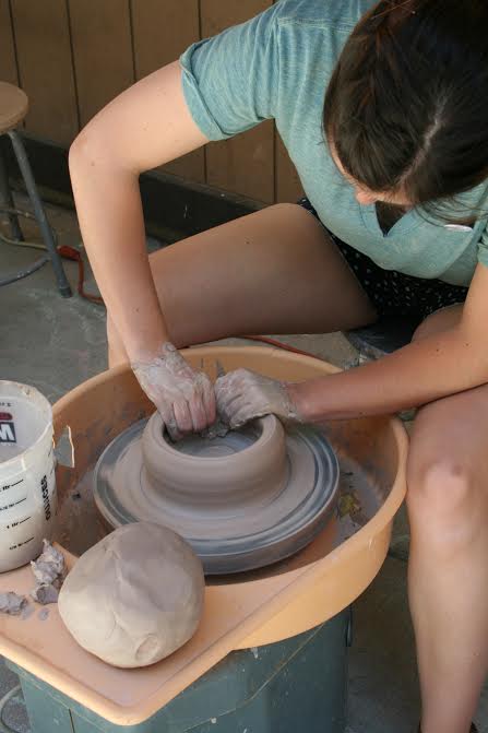 Colleen Garland, 23, helped to assist other students who were interested in pottery at the Art Festival.