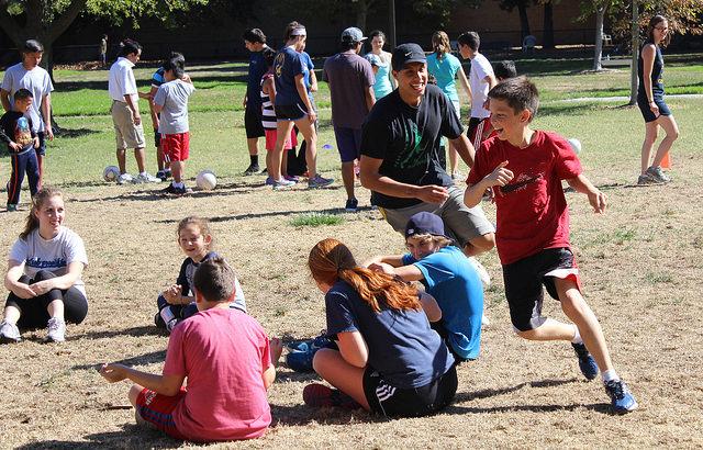 Diablo Valley College student Christian Giron runs a soccer warm-up with a player during a soccer program working to help children with special and typical needs.