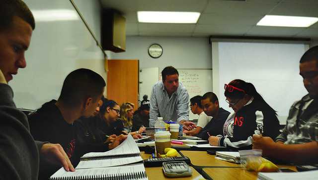 Math Professor Read Vanderbilt helps students work through problems in the new Statway class that employs collaborative problem solving.