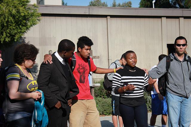 From left to right, Students Karen Compere, Aaron Houstone, Cameron Cabading, Charlise Nwoha, and Andrew Ramierez, speak in front of other students about their experiences during the Mike Brown vigil in the Library quad on Nov. 26. 