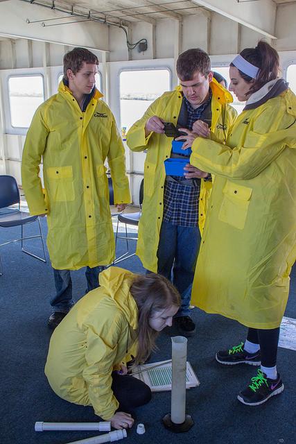 Erik Norton (left), Jeff Weinberg (center), Kiana Shokouh (right), Audrey Hansen-Jud (on the floor) testing the water samples they collected from the delta during their field trip in Antioch on February 21st, 2015.
