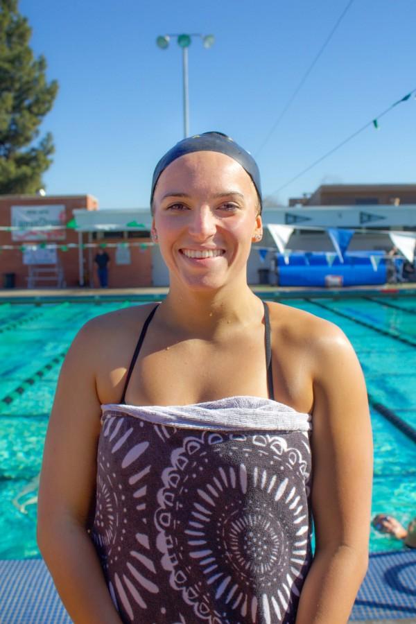 Kelsey Leonard the team captain standing next to the pool during the 10 minute
 break after completing one of her match with Mt. San Antonio College swimmers at the first meet of the 2015 season on January 30th.