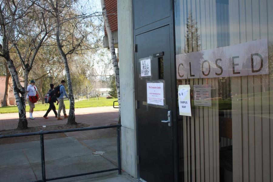 DVC students passing the closed Computer Center on the first floor of the library.