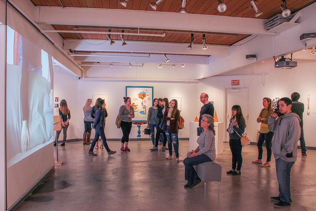 DVC students gather around to watch a video at the DVC art gallery on March 9, 2015