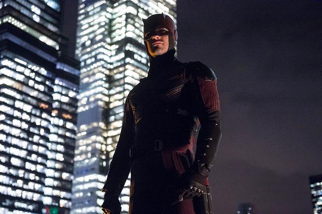 Charlie Cox as the masked vigilante Daredevil stands above the city in Marvels new series.