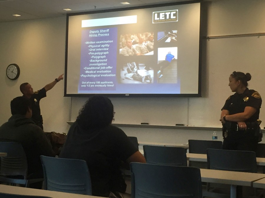 Deputy sheriff’s Fred Quichocho and Stephanie Smith show PowerPoint to DVC students interested in law enforcement opportunities. 