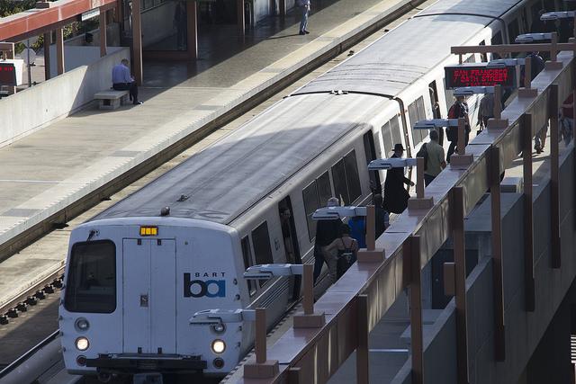 Commuters exit crowded SanFrancisco bound train.