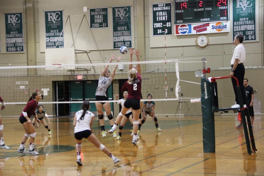 Madison Hatch and Noelle Vleisides block a spike from and outside hitter from Sierra College
