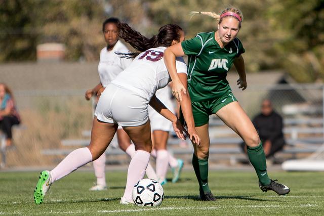 SCC defender Maria Martinez (19) drops a shoulder into Hannah Kidson in a game between DVC and SCC at DVC on Tuesday, Oct. 6, 2015. The Vikings won 3-0.