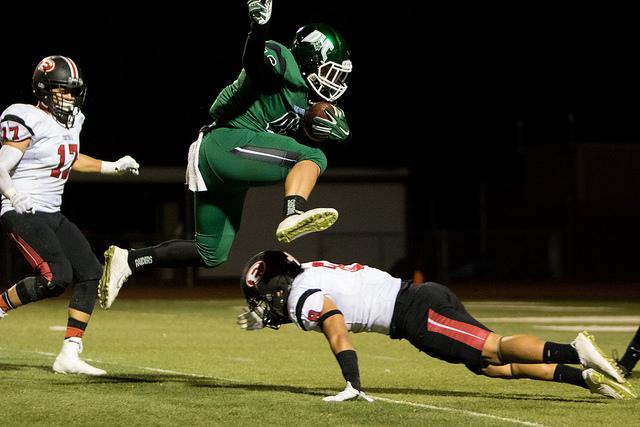 DVC fullback Rodrick Sweeney (46) jumps over Foothill defensive back Dustin Nascimento (8) to carry the ball just one yard short of the endzone in a game between DVC and Foothill College at DVC in Pleasant Hill, Calif. on Friday, Oct. 23, 2015. The Vikings won 52-13.