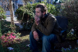 Chris Harless a homeless man from Martinez sits smoking a cigarette while discussing the new ordinances in Martinez on Feb. 8, saying that the cops stop him at least twice a day.